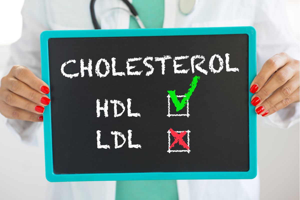 Dokter memegang papan tulis berisi tulisan cholesterol HDL dan LDL