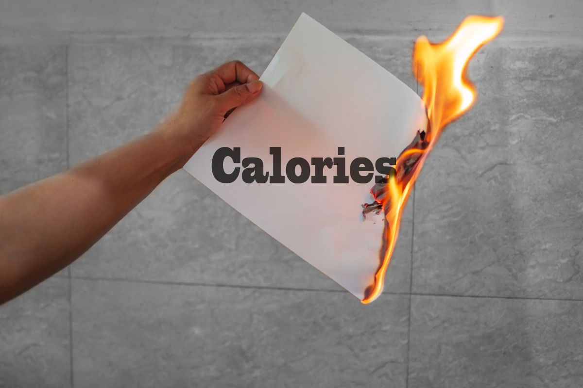 Seseorang membakar kertas dengan tulisan kalori