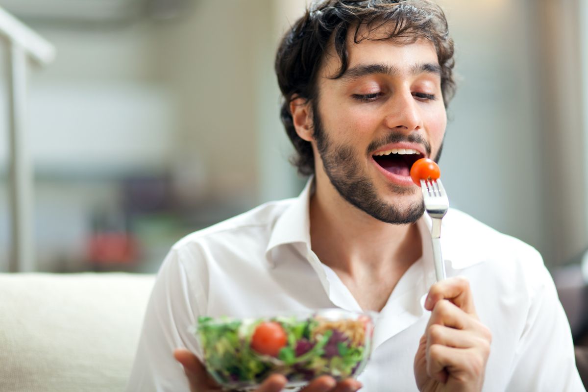 Seorang pria sedang menyantap makanan sehat